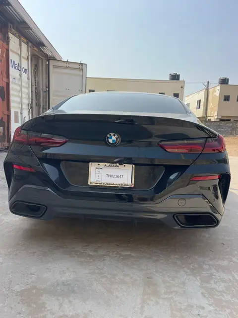 A black BMW in the container yard
