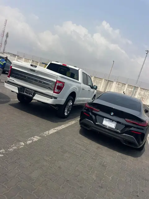 A pickup and a BMW in the port yard